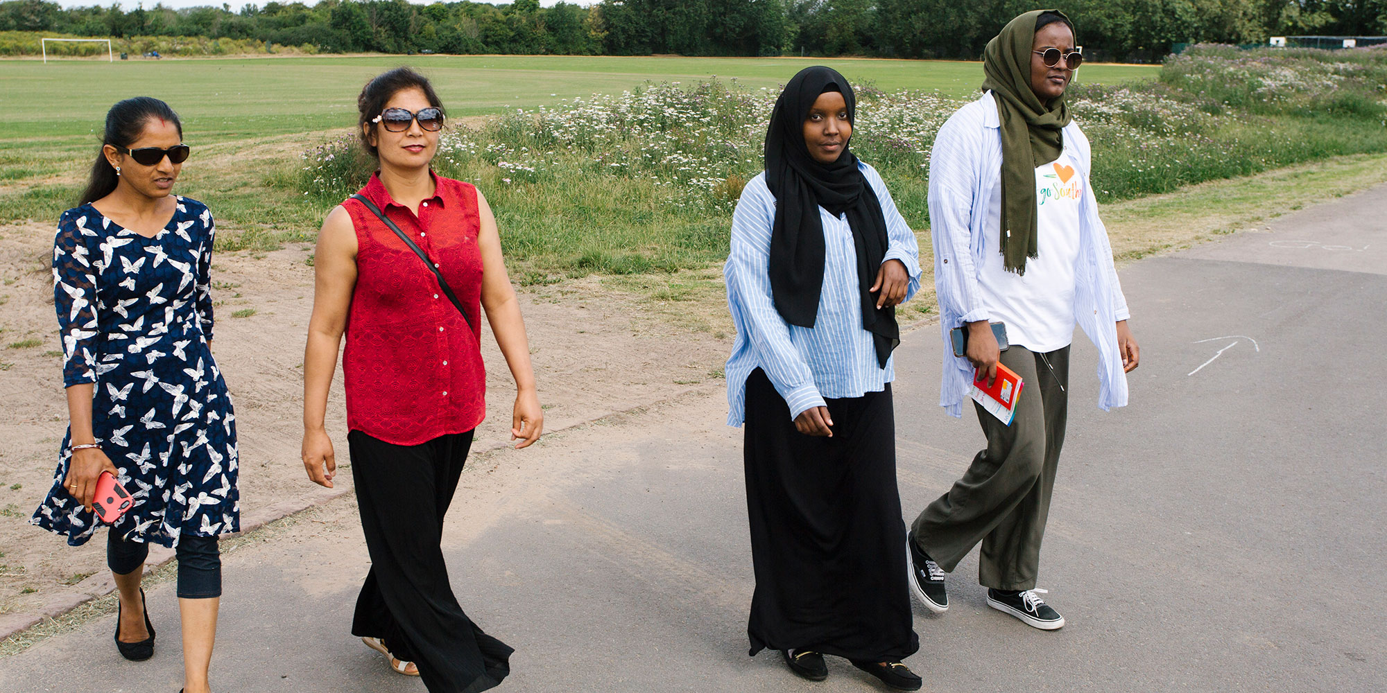 Four women from different ethnic backgrounds out walking.